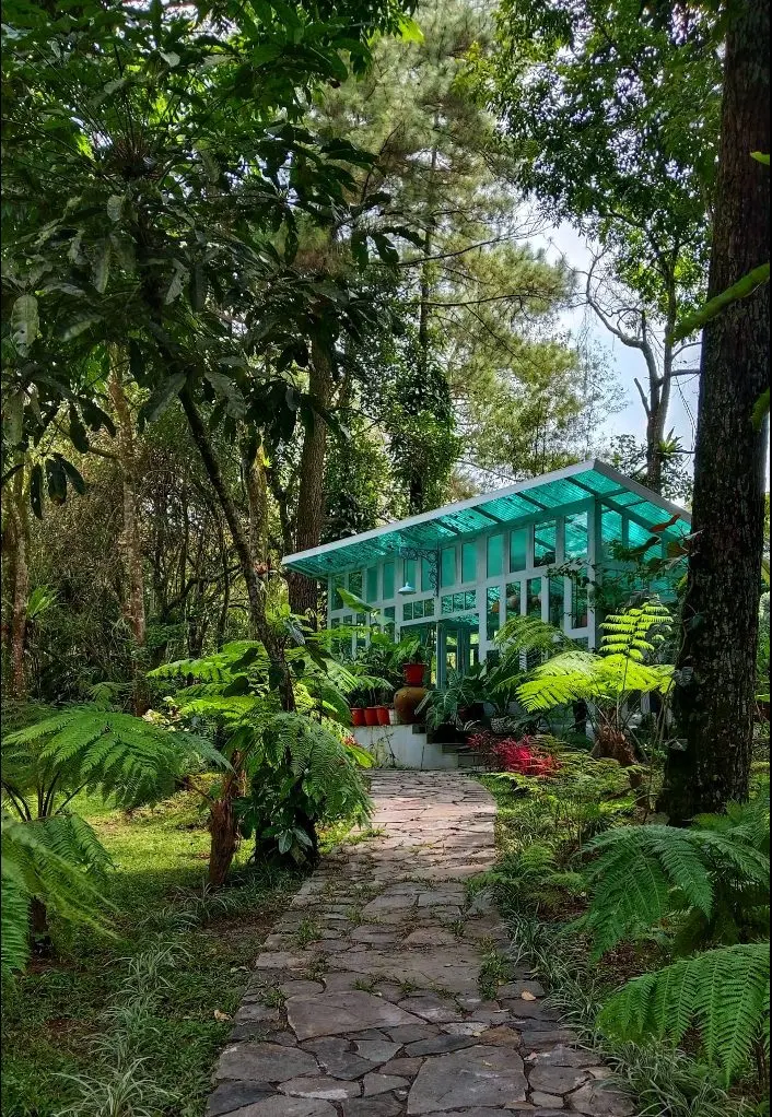 The glasshouse at the end of the stone path