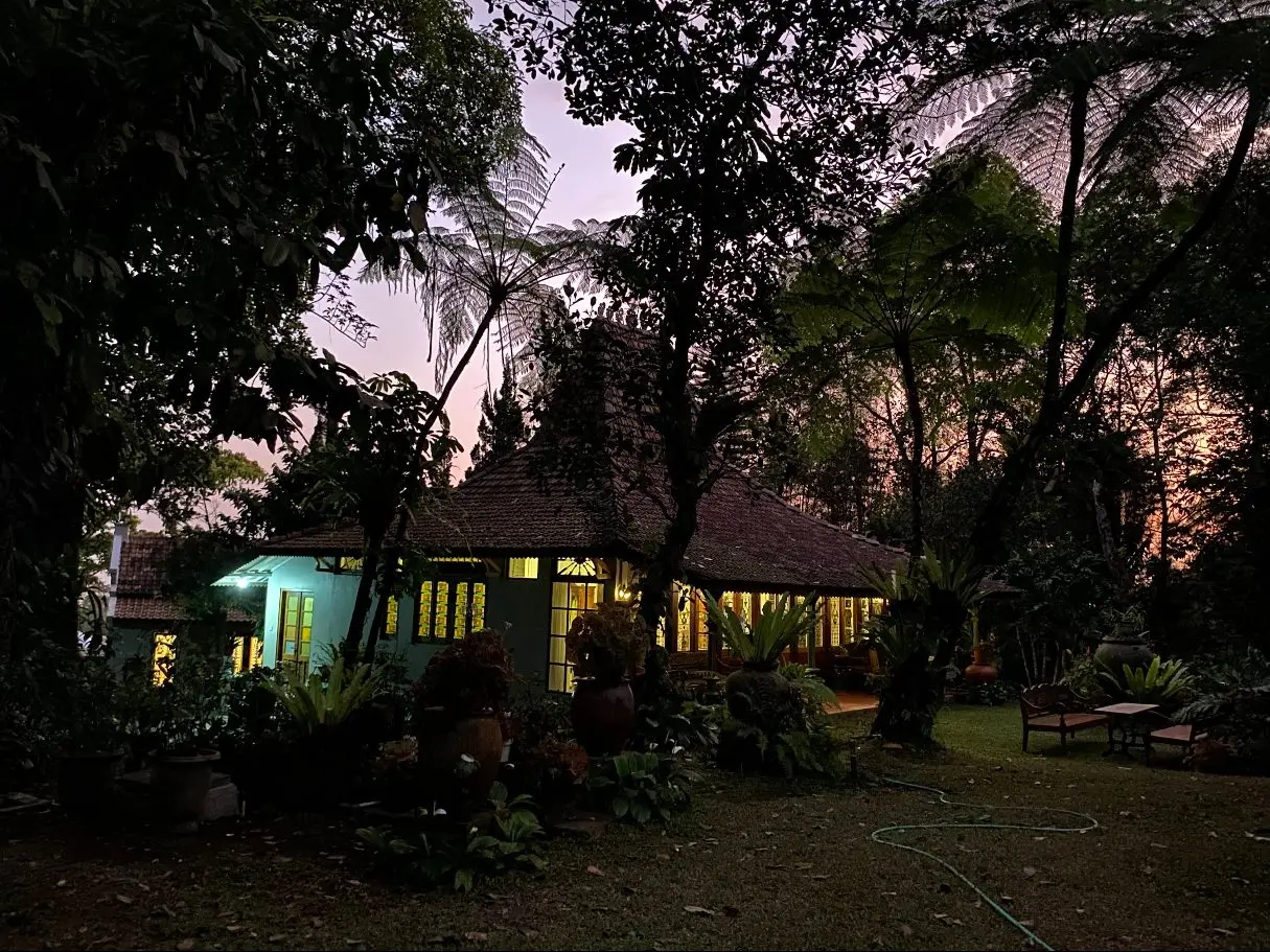 The villa glowing at dusk