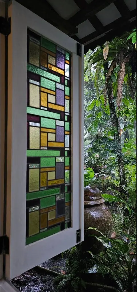 Stained-glass shutters opening to the garden